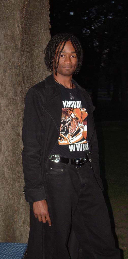 Priest, relaxing against a tree.